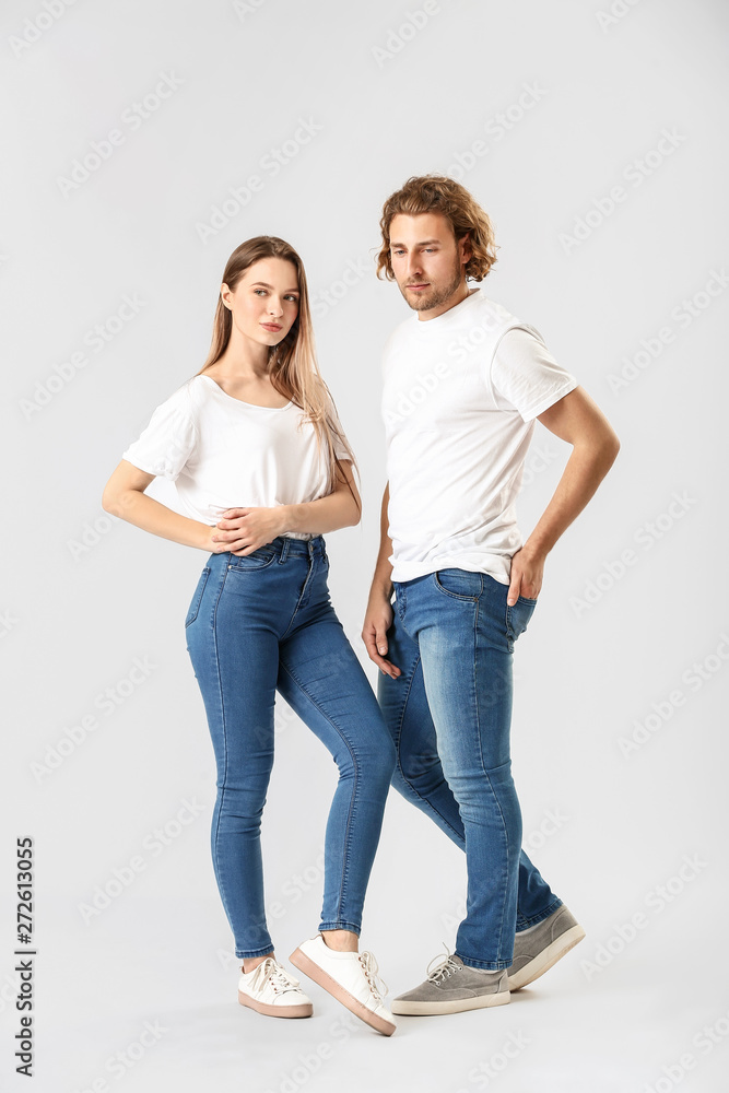 Stylish young couple in jeans on white background Stylish young couple in jeans on white background