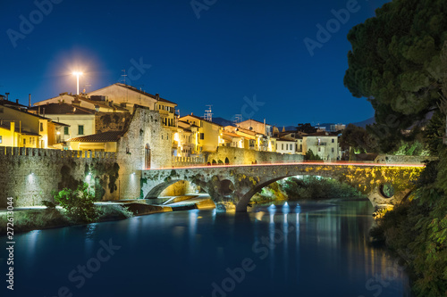 Medieval stone bridge and Mercatale Gate  Porta Mercatale  at dusk in Prato  Tuscany  Italy