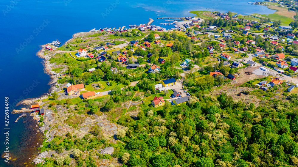 Aerial of island village and surrounding landscape on a sunny summer day. Location Hasslo island in Blekinge archipelago, Sweden.