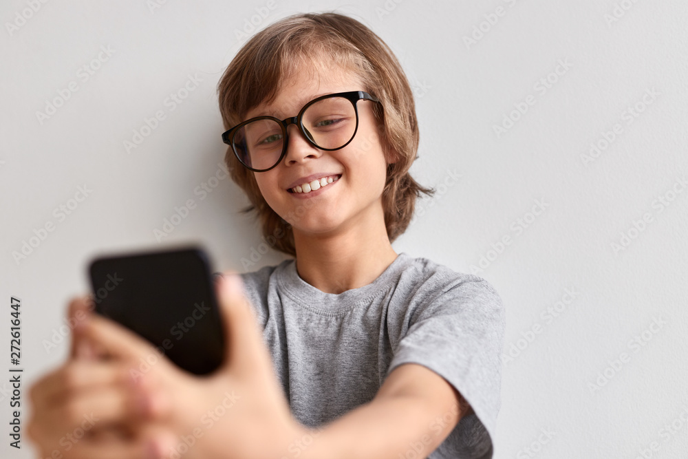 Smiling boy taking selfie Smiling boy taking selfie