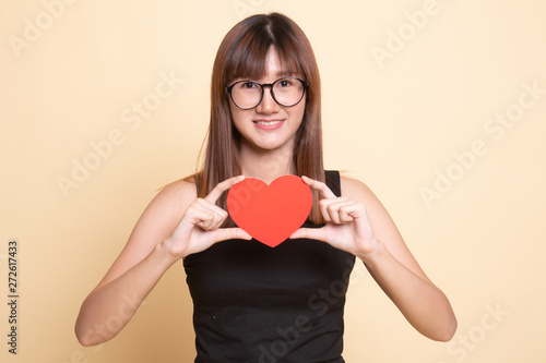 Asian woman with red heart. © halfbottle