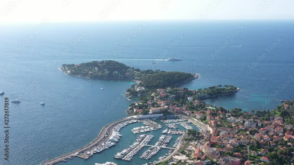 Saint Jean Cap Ferrat aerial back traveling mega yacht harbor and luxury residential coastline area France morning sunny day Saint Jean Cap Ferrat aerial back traveling mega yacht harbor and luxury residential coastline area France morning sunny day