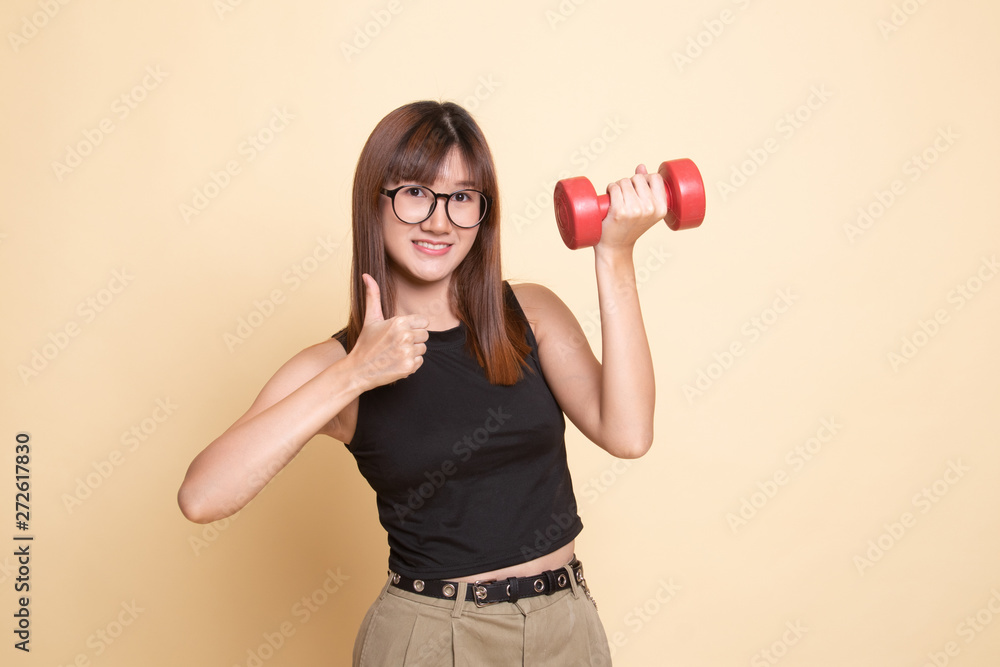 Healthy Asian woman thumbs up with dumbbells. Healthy Asian woman thumbs up with dumbbells.