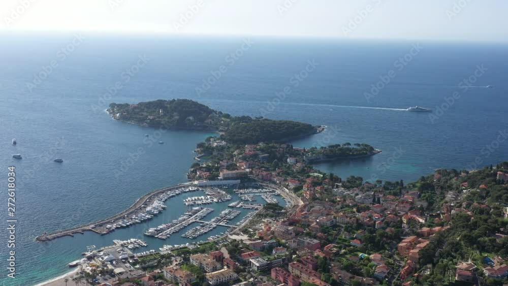 Aerial view of Saint Jean cap Ferrat mediterranean sea with a mega yacht, harbor and residential area France Aerial view of Saint Jean cap Ferrat mediterranean sea with a mega yacht, harbor and residential area France