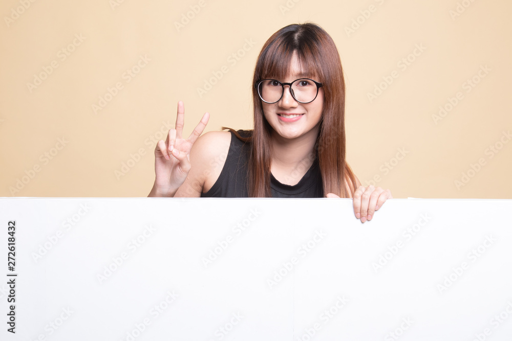 Young Asian woman show victory sign with blank sign.