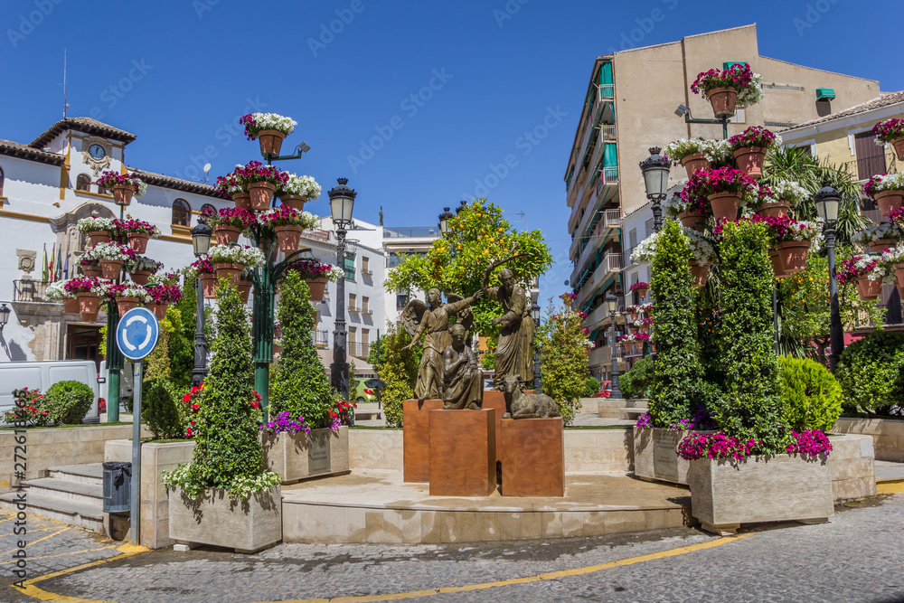 Statue and flowers on the central square of Alcaudete, Spain