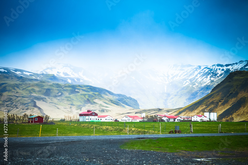 Small willage (few houses) on a stony rocky mountain landscape of Iceland. Toned