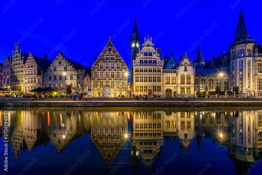 View of Graslei quay and Leie river in the historic city center in Ghent (Gent), Belgium. Architecture and landmark of Ghent. Night cityscape of Ghent.