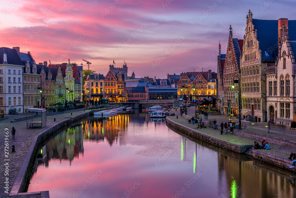 View of Graslei, Korenlei quays and Leie river in the historic city center in Ghent (Gent), Belgium. Architecture and landmark of Ghent. Sunset cityscape of Ghent.