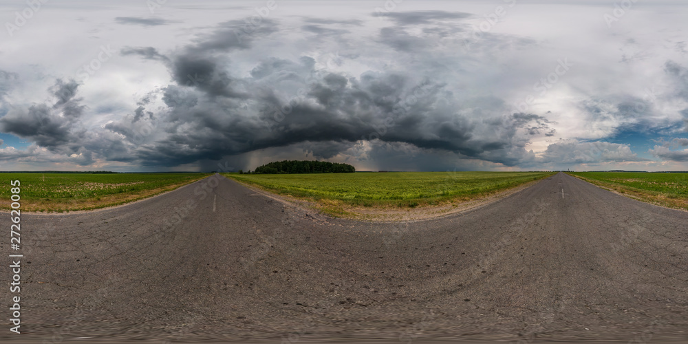 full seamless spherical hdr panorama 360 degrees angle view on asphalt road among fields in evening with awesome black clouds before storm in equirectangular projection, VR AR virtual reality content