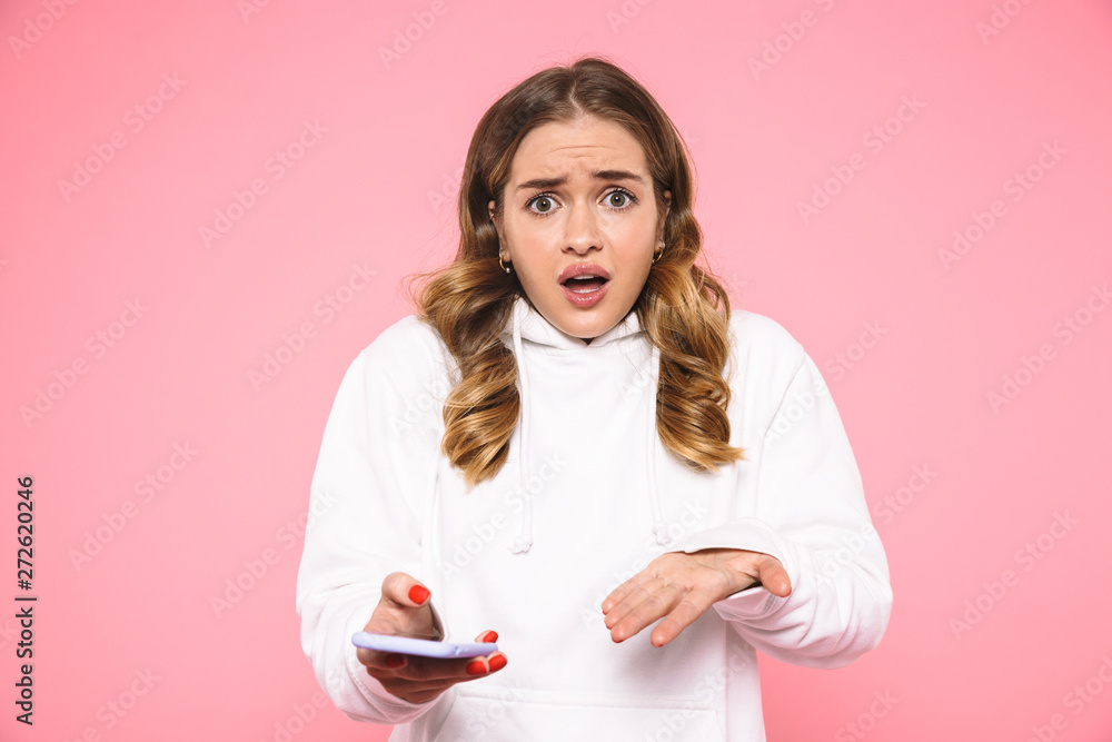 Shocked blonde woman wearing in casual clothes looking at camera Shocked blonde woman wearing in casual clothes looking at camera