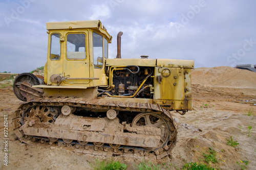  Old, rusty, yellow Caterpillar tractor.