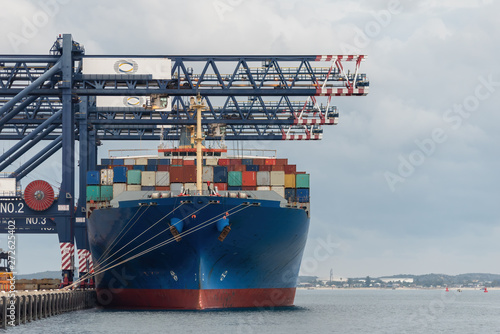 cargo ship at dock waiting to be unloaded