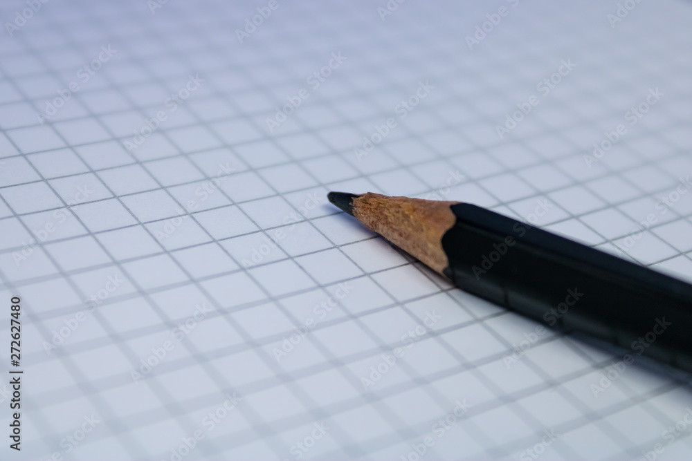 Blank notebook page with the pencil, closeup of the pencil on the empty notepad sheet - Image Blank notebook page with the pencil, closeup of the pencil on the empty notepad sheet - Image