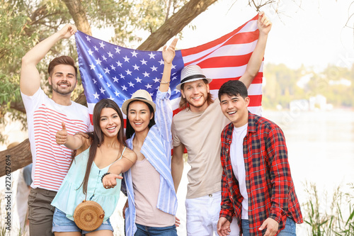 Young people with USA flag outdoors. Independence Day celebration © Pixel-Shot