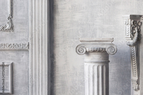 Stone column on light gray background. Close-up, copy space, front view photo