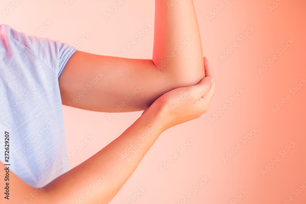 Woman feels pain in elbow. People, healthcare and medicine concept
