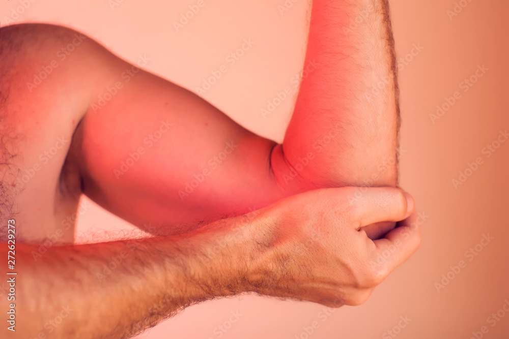 Man feels pain in elbow. People, healthcare and medicine concept Man feels pain in elbow. People, healthcare and medicine concept