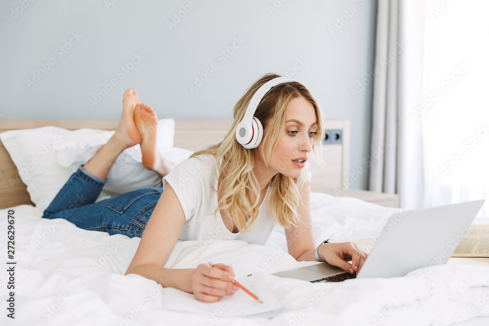 Beautiful young blonde woman relaxing in bed Beautiful young blonde woman relaxing in bed