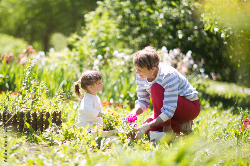 Grandmother with her granddaughter working in the garden. Grandmother with her granddaughter working in the garden.