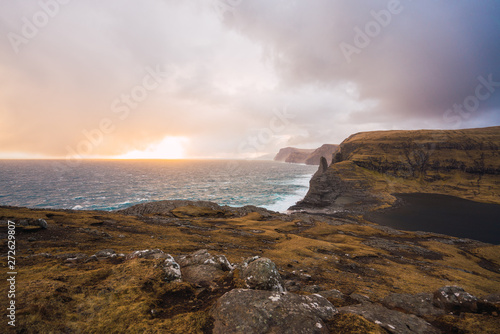 Sun rising over sea on cloudy sky