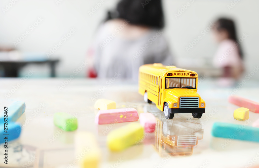 Yellow school bus toy model.Hi-key and very shallow depth of field composition. Yellow school bus toy model.Hi-key and very shallow depth of field composition.