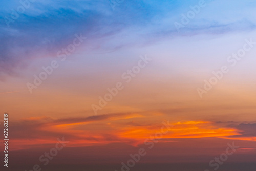 Dramatic blue and orange sky and clouds abstract background. Red-orange clouds on sunset sky. Warm weather background. Art picture of sky at dusk. Sunset abstract background. Dusk and dawn concept © Artinun