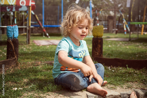 Little boy sitting at the playground