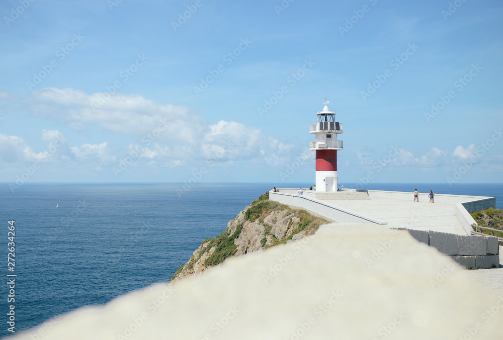 A white and red lighthouse in northern Spain
