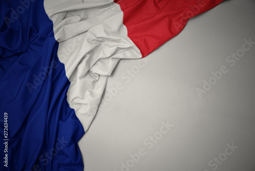 waving national flag of france on a gray background.