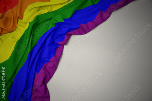 waving gay rainbow flag on a gray background.
