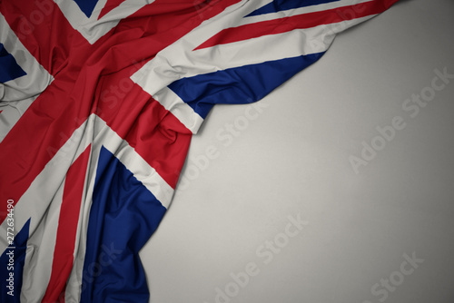 waving national flag of great britain on a gray background.