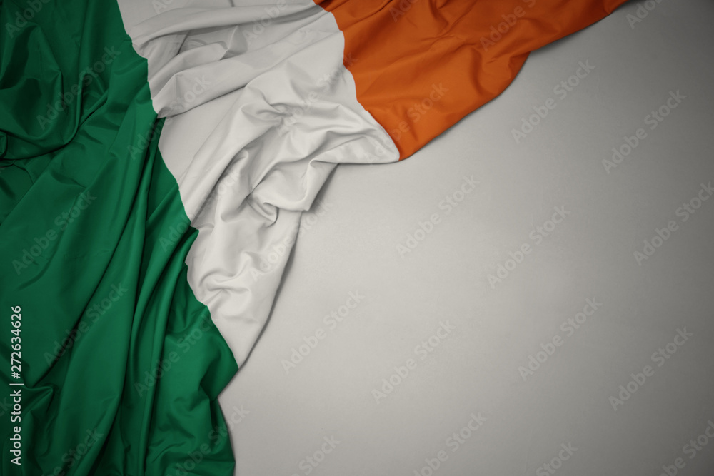 waving national flag of ireland on a gray background.