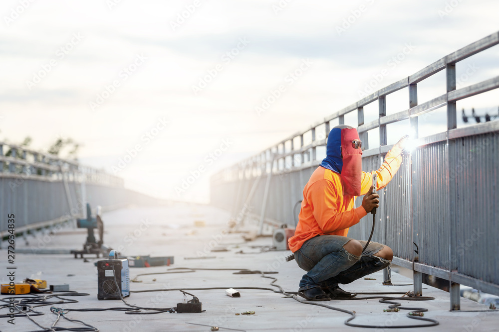 Man welder working on bridge construction. Man welder working on bridge construction.