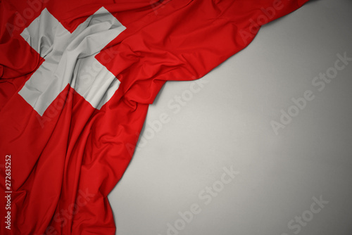 Fotografie waving national flag of switzerland on a gray background.