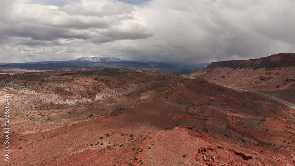 Aerial view of huge red sandstone cliffs in Moab, Utah. Scenic landcape, nature, desert. Day, cloudy Aerial view of huge red sandstone cliffs in Moab, Utah. Scenic landcape, nature, desert. Day, cloudy
