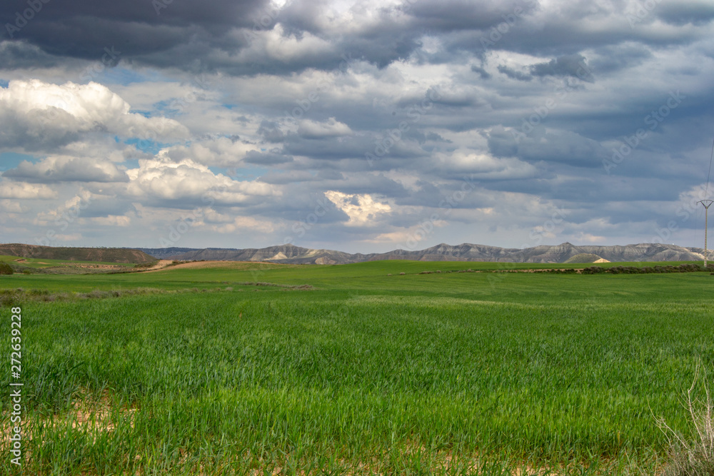 Fototapeta premium Beautiful storm landscape surroundings of Zaragoza rain rainbow and horizon hills