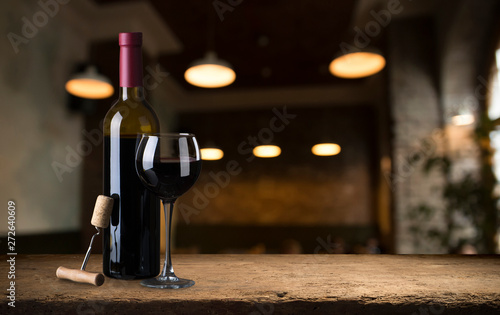 Red wine glasses and bottle on stone background. Top view with copy space