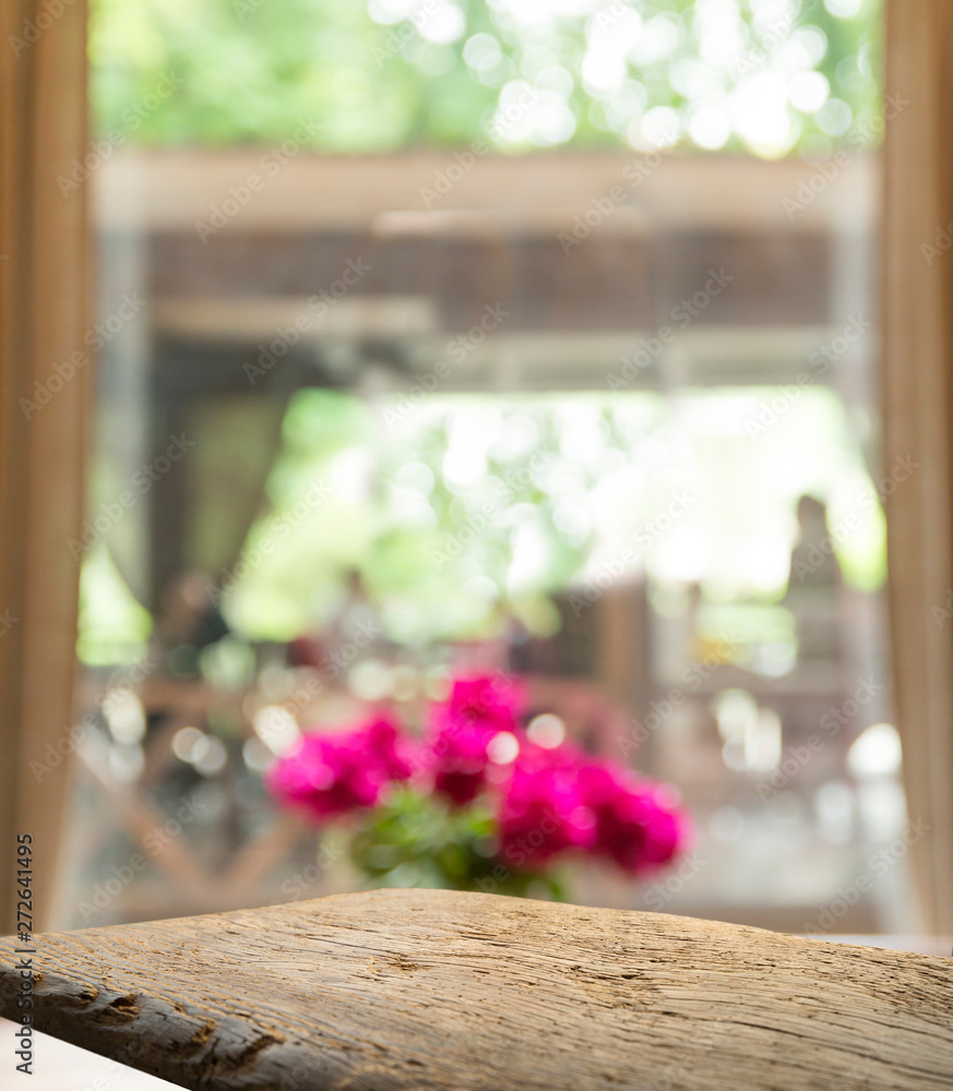 Empty of wood table top on blur of curtain with window view green from tree garden background.For montage product display or design key visual layout Empty of wood table top on blur of curtain with window view green from tree garden background.For montage product display or design key visual layout