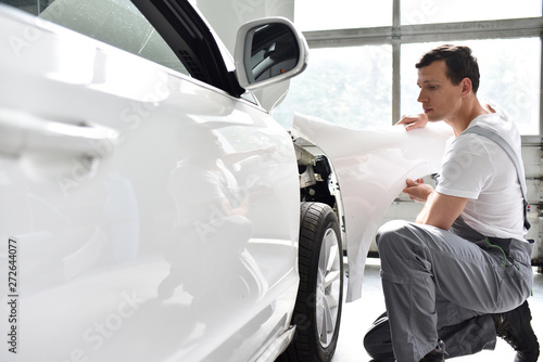 car mechanic repairs car bodywork of a vehicle after a traffic accident photo