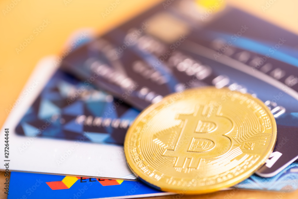 Bitcoin golden coin and VISA credit cards. virtual cryptocurrency concept. buy and sell bitcoin by credit card. Bitcoin golden coin and VISA credit cards. virtual cryptocurrency concept. buy and sell bitcoin by credit card.