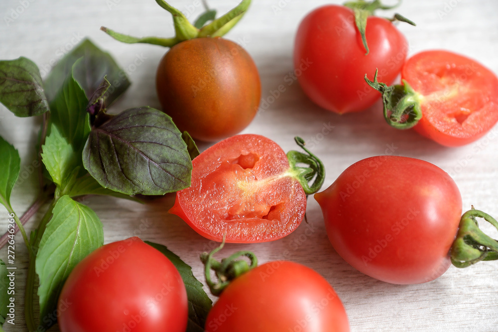 Fresh ripe tomatoes on white background top view. Tomato red vegetable concept, copy space for text with basil leaves. Panorama or wide banner. Fresh ripe tomatoes on white background top view. Tomato red vegetable concept, copy space for text with basil leaves. Panorama or wide banner.