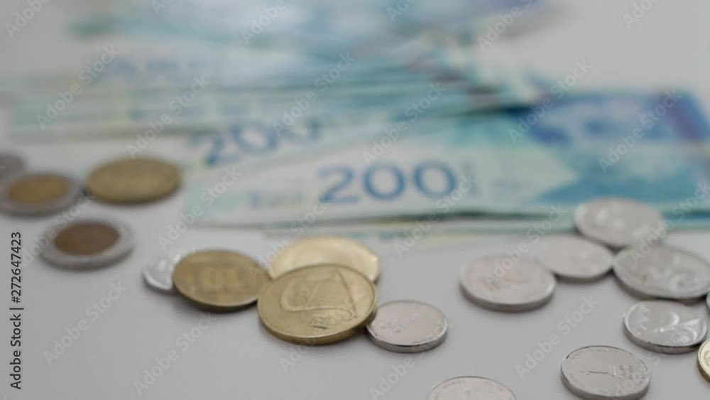 Camera moving across Israeli currency - shekel - showing coins and bills Camera moving across Israeli currency - shekel - showing coins and bills