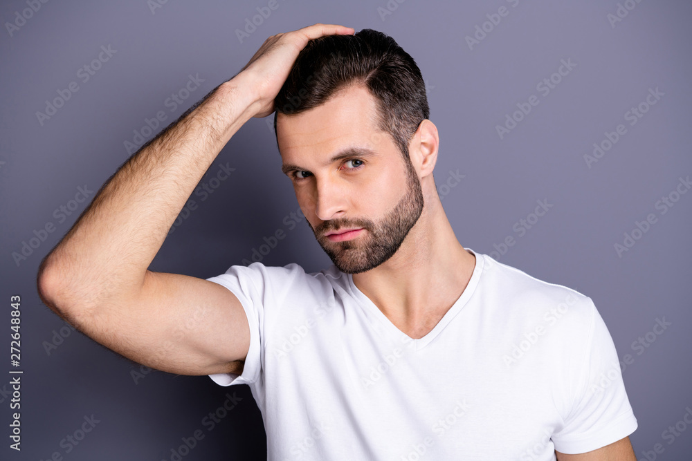Close up photo amazing he him his macho perfect appearance touch arm hand groomed head haircut stylist visit not smiling calm look mirror shower wear casual white t-shirt isolated grey background Close up photo amazing he him his macho perfect appearance touch arm hand groomed head haircut stylist visit not smiling calm look mirror shower wear casual white t-shirt isolated grey background