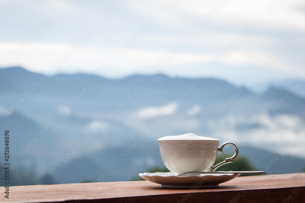 Coffee in white cup at the morning time have mountain background Coffee in white cup at the morning time have mountain background