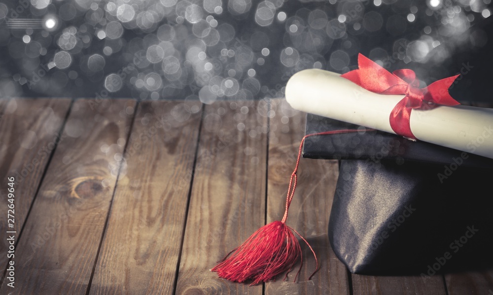 Graduation cap and diploma on background Stock Photo | Adobe Stock