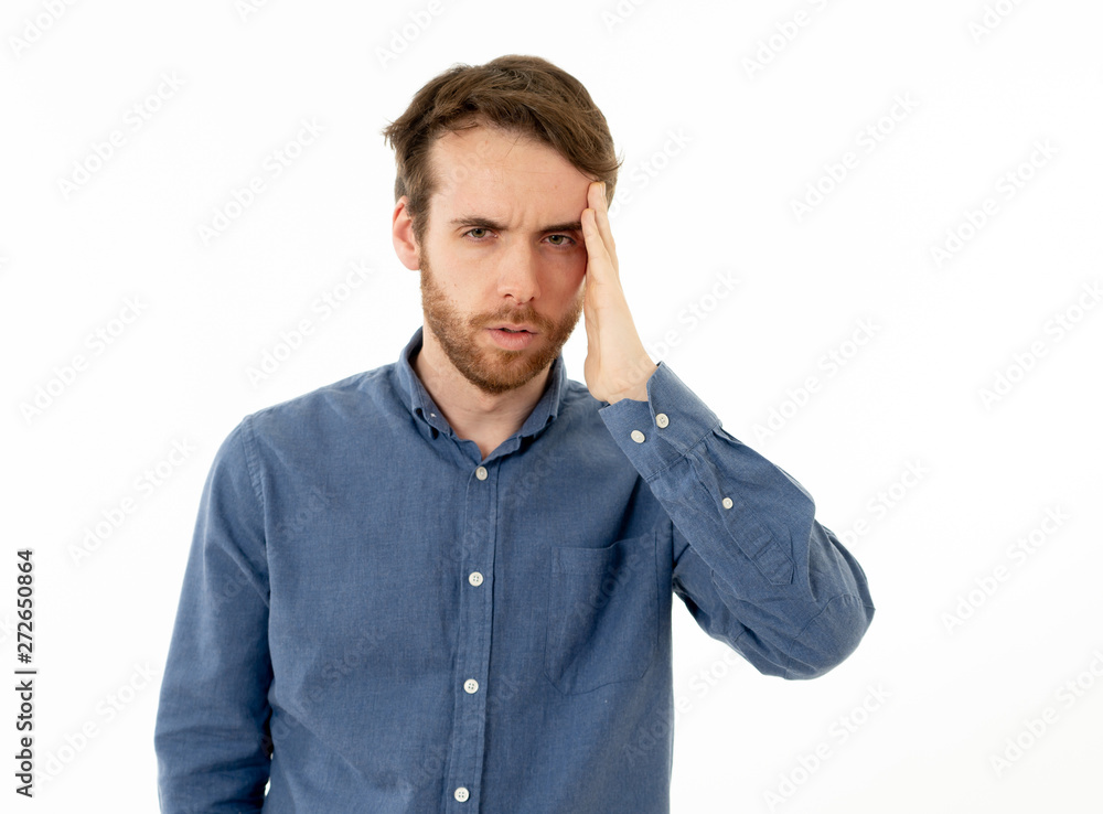 Portrait of sad man in pain having headache and migraines Portrait of sad man in pain having headache and migraines