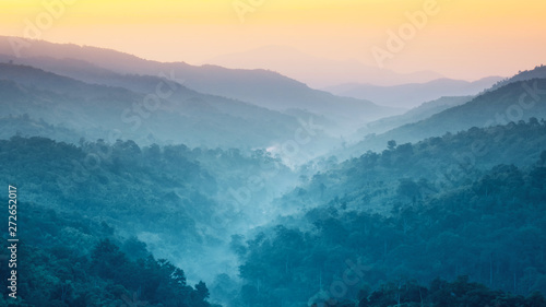 earth day and environment care travel concept from beautiful landscape of tropical forest with haze with soft focus of layer mountain background © tickcharoen04