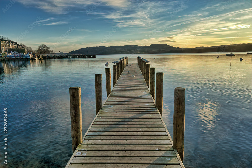 A view of a jetty on Windermere at sunset.
