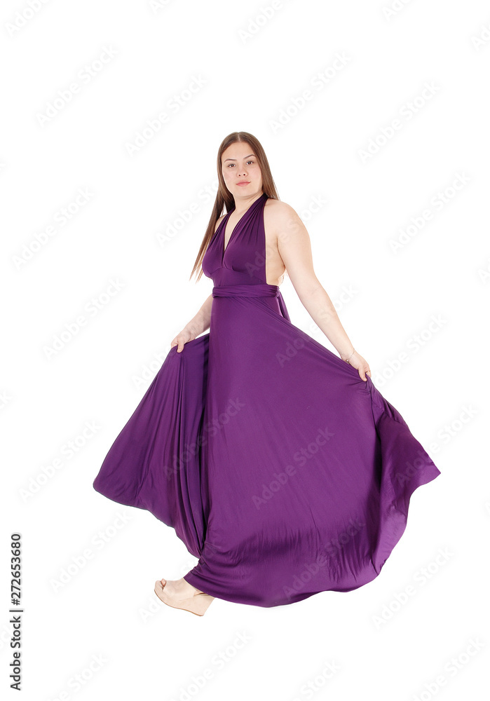 Teenager girl standing in her long burgundy prom dress